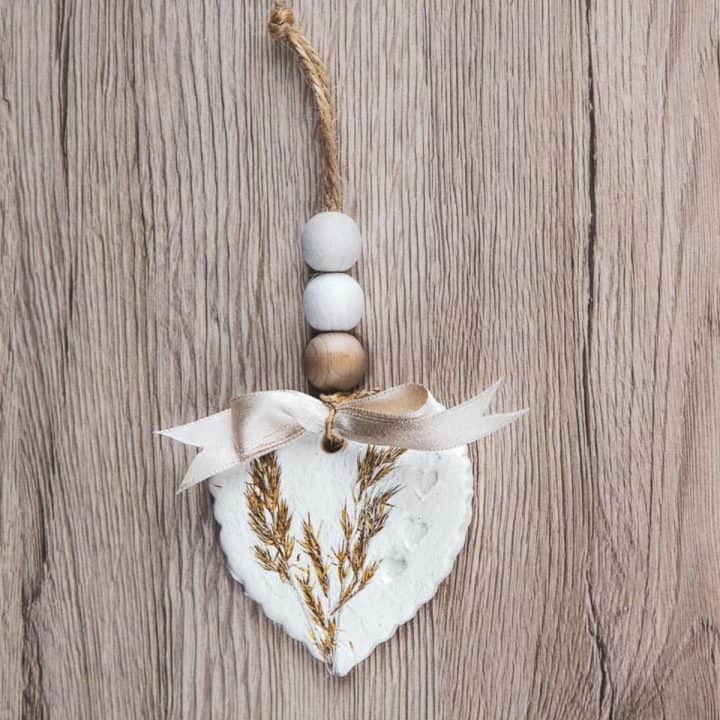 A clay heart ornament with wooden beads