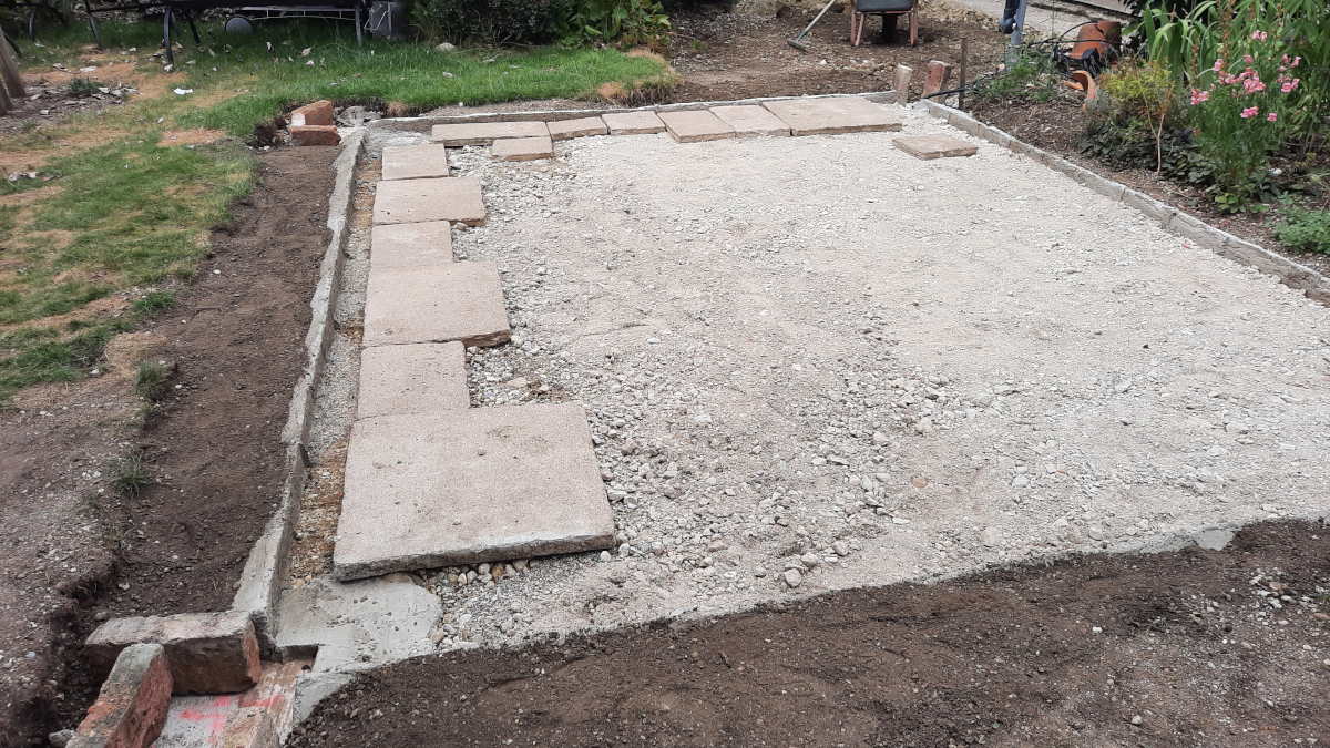 how to build a paver patio - chalkingupsucccess.com Paver stones laid out ready to build a paver patio