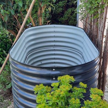 A black metal raised garden bed.