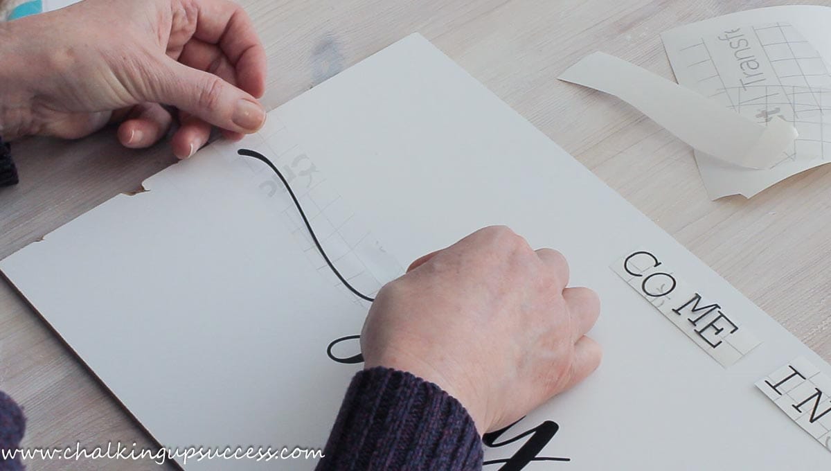 Adding a swirl embellishment to each side of the text on the farmhouse sign.