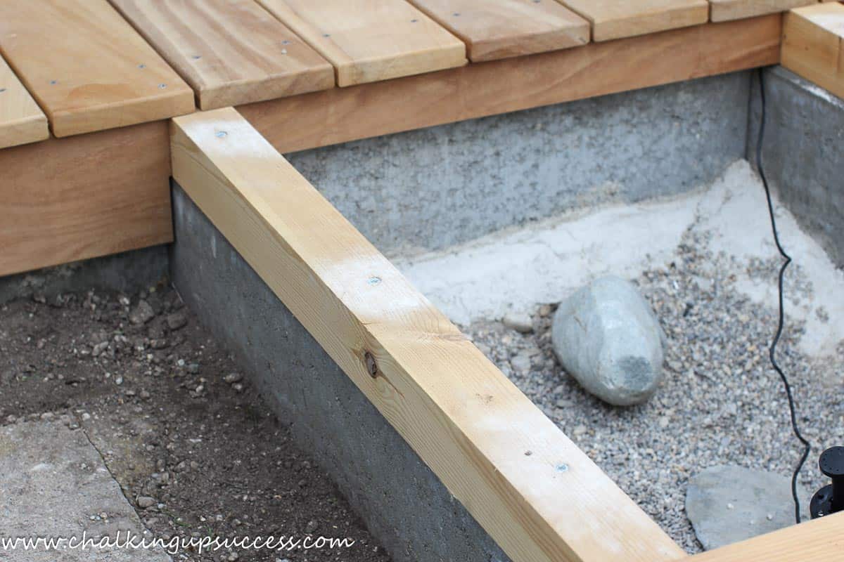 DIY above-ground-pond from ChalkingUpSuccess.com Close-up of concrete and wood pond base structure.