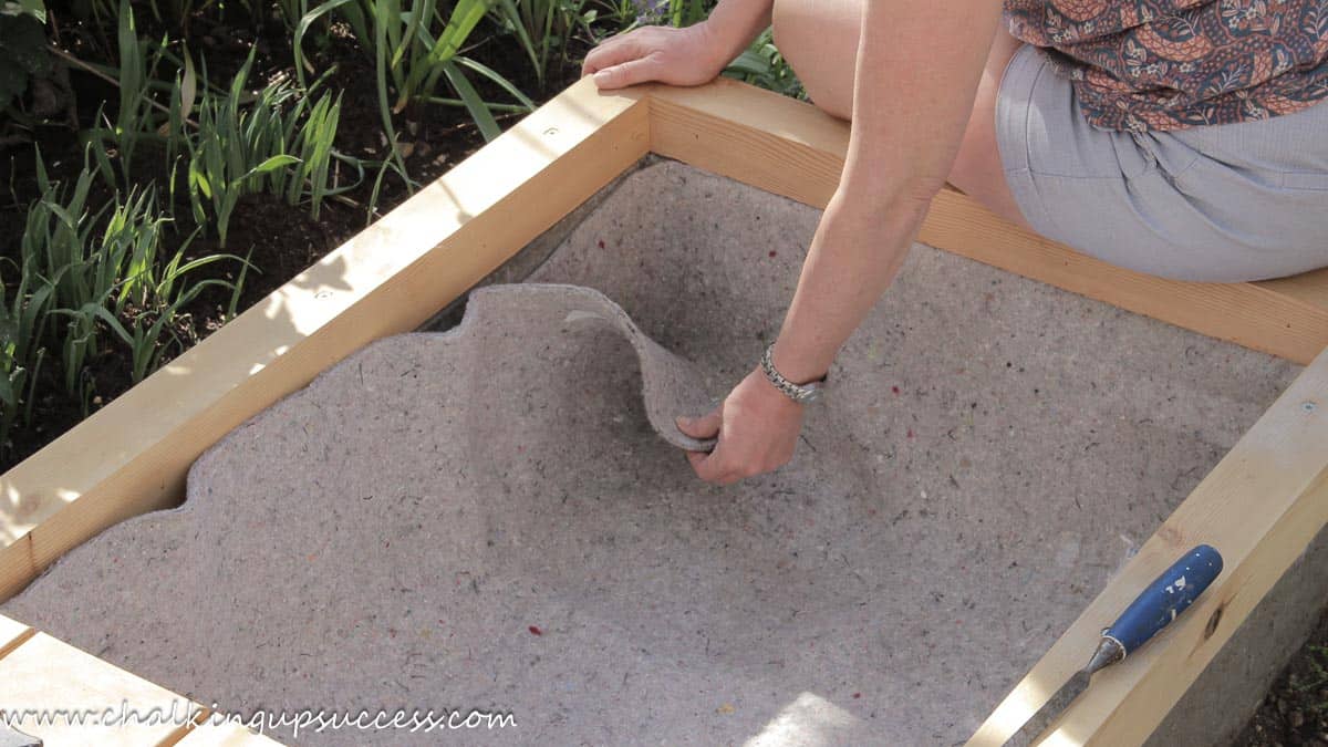 DIY above-ground-pond from ChalkingUpSuccess.com Pond fleece neatly laid inside the above-ground pond structure.